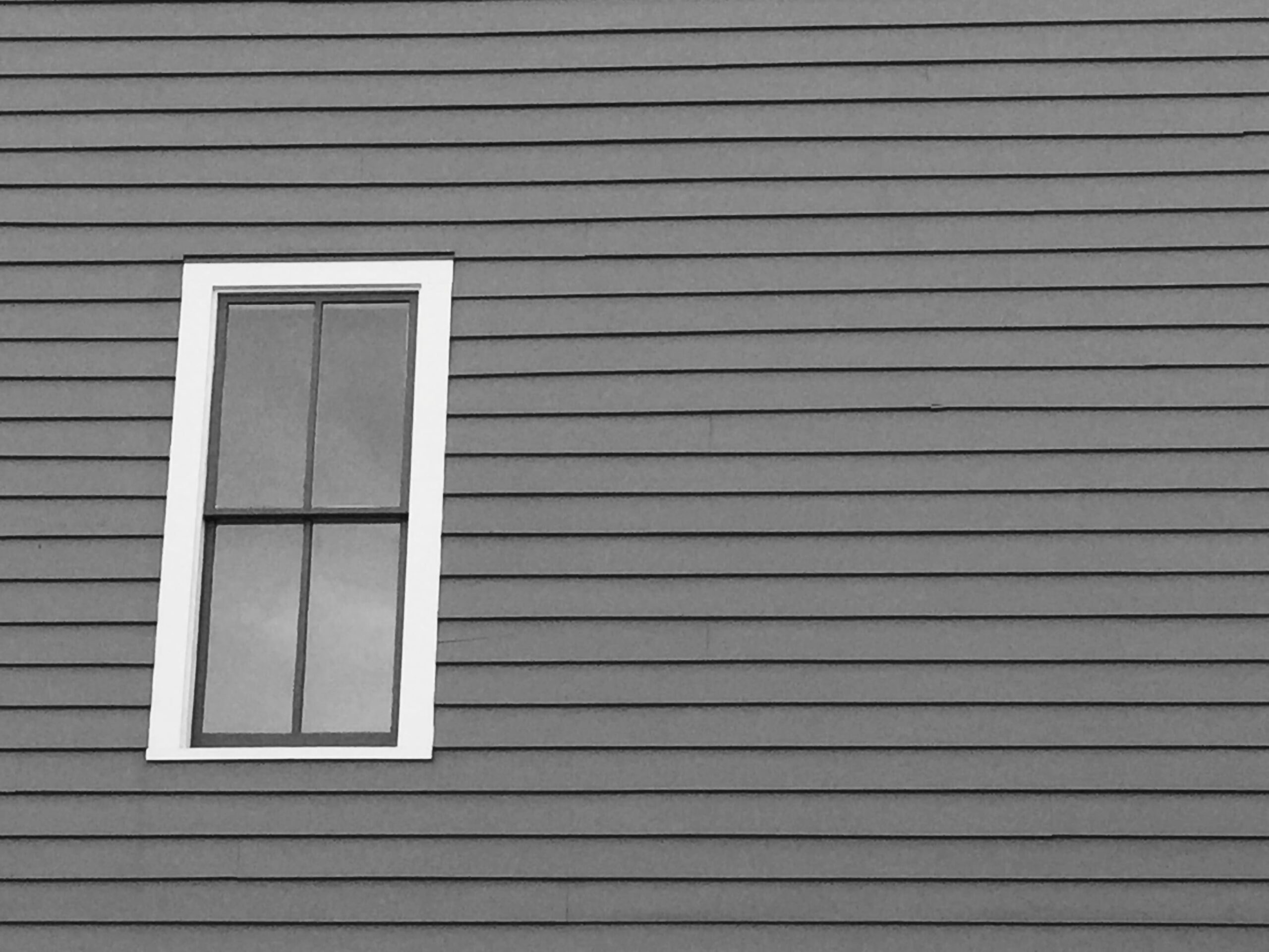 window-on-gray-siding-of-a-building-2026-03-09-22-10-40-utc